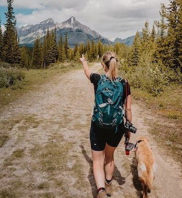 women with dog hiking, dog and girl hiking