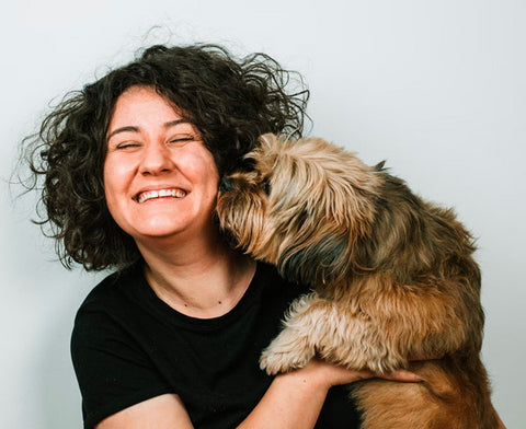dog kissing the girl